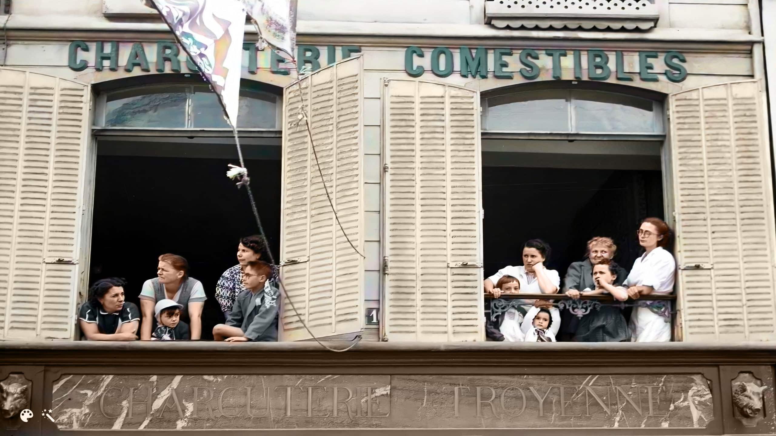 Pierre Boillon y su familia observan el paso del Tour de Francia por su negocio en Bar-sur-Aube. Foto cortesía de Pierre Boillon, coloreada y mejorada por MyHeritage