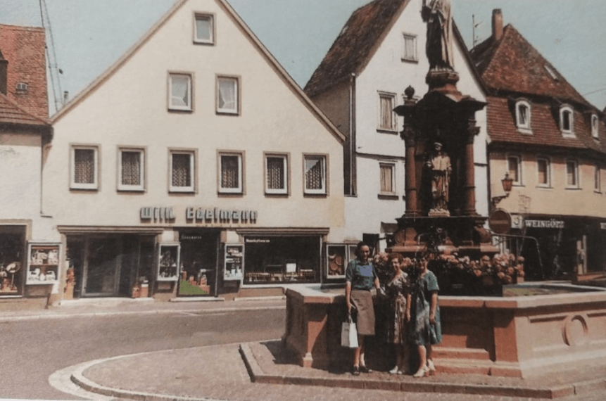 Hanna outside the shop during a 1980s visit to Germany (Hanna center) (Hanna Ehrereich credit).