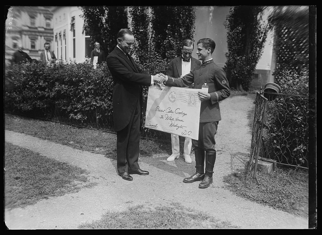 President Coolidge receives a giant envelope with “birthday greetings from 20,000 Mass citizens” from Louis Demontreux, Honor. Messenger of the Western Union from Boston, July 4, 1924. Courtesy of the Library of Congress