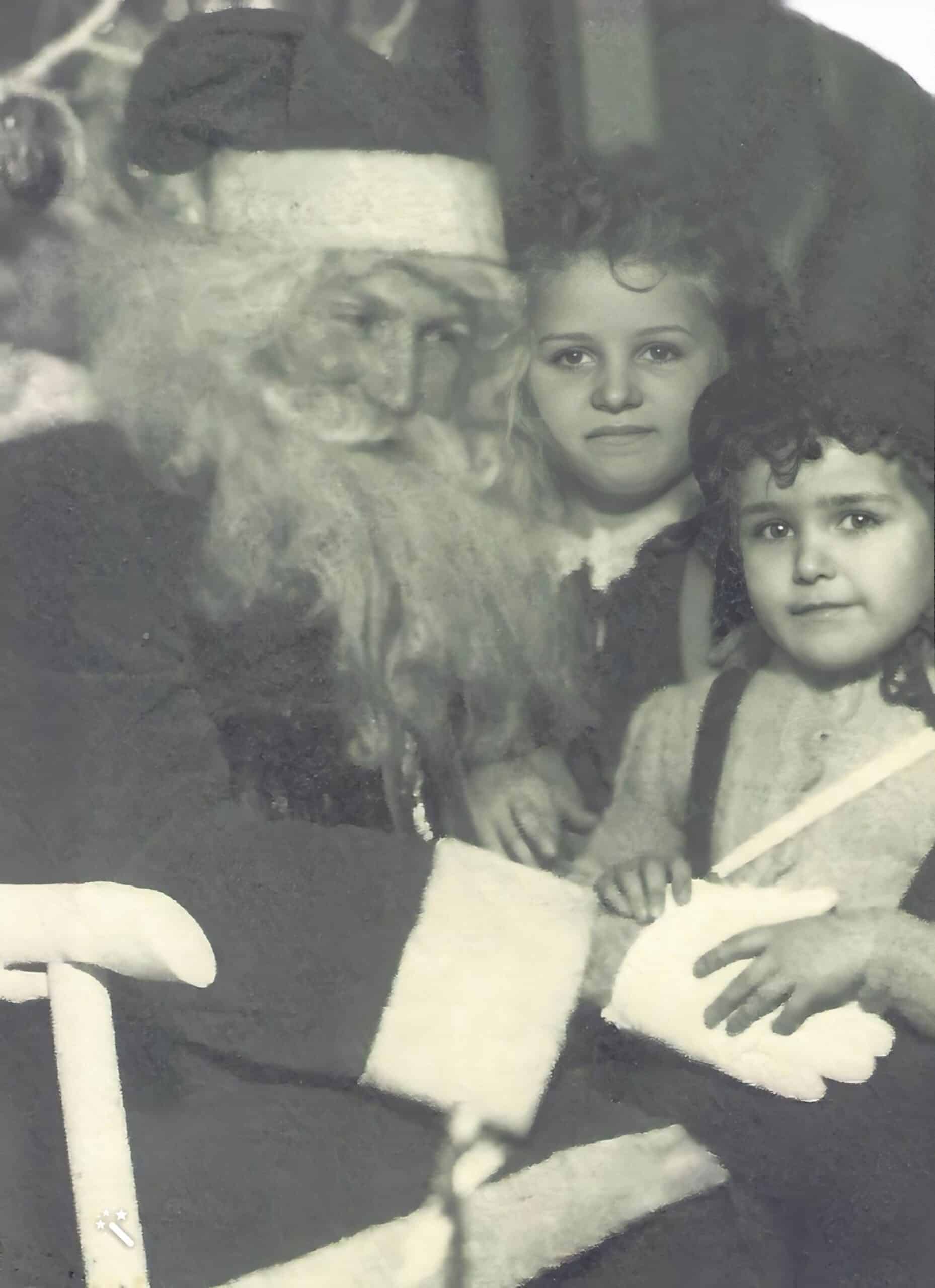 Carol und Roberta auf dem Schoß des Weihnachtsmanns. Verbessert und repariert mit MyHeritage