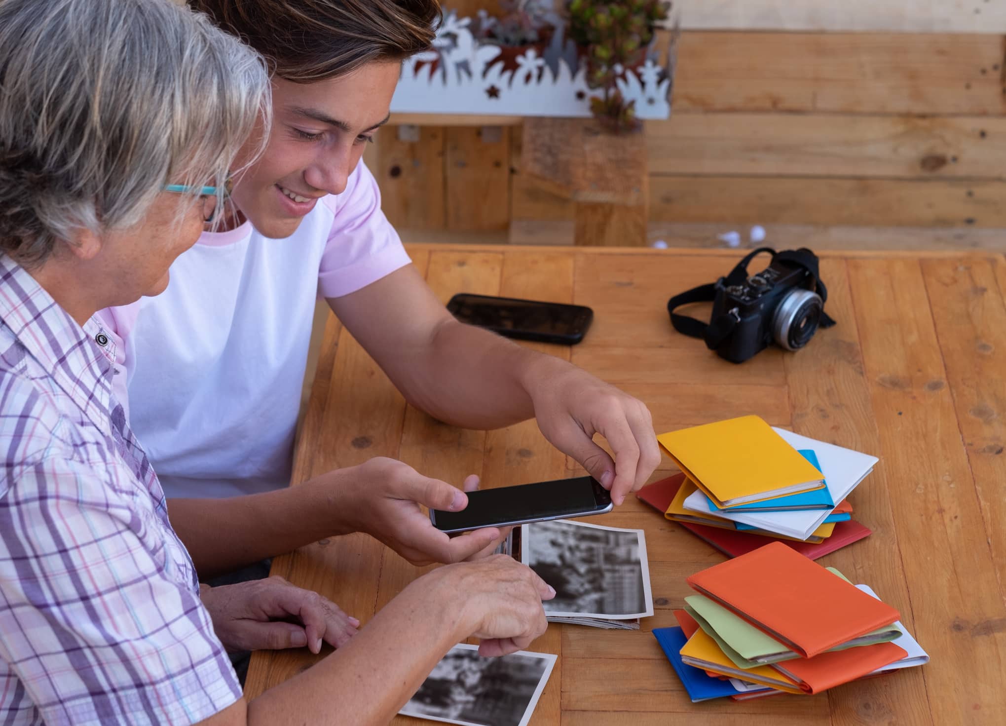 A grandmother and grandson scanning photos easily using Reimagine photo scanner and photo editing app