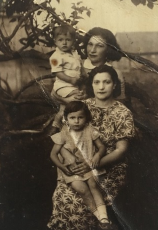 My grandmother’s sister Libke Chwojnik (wearing a dress with a pattern), with her children Miriam and Chaim, all of whom died. Her sister Leah Chwojnik (top right) came to Israel with Dr. Chwojnik’s help and was saved.
