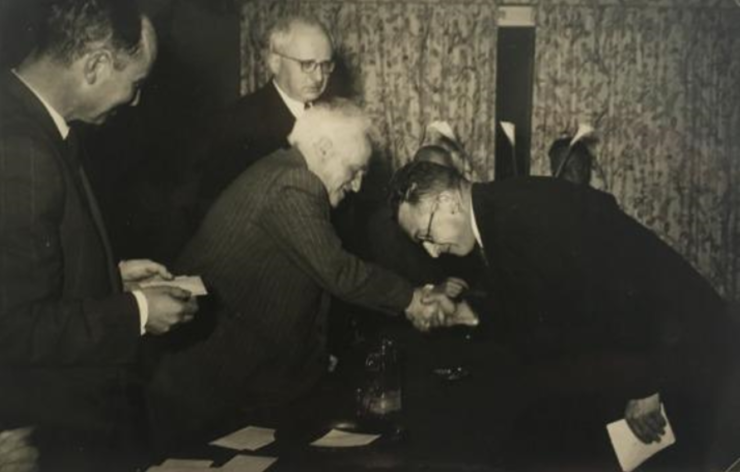 Dr. Menachem Chwojnik bowing to David Ben Gurion, Israel’s first prime minister, after winning Israel’s chess championship in 1951.