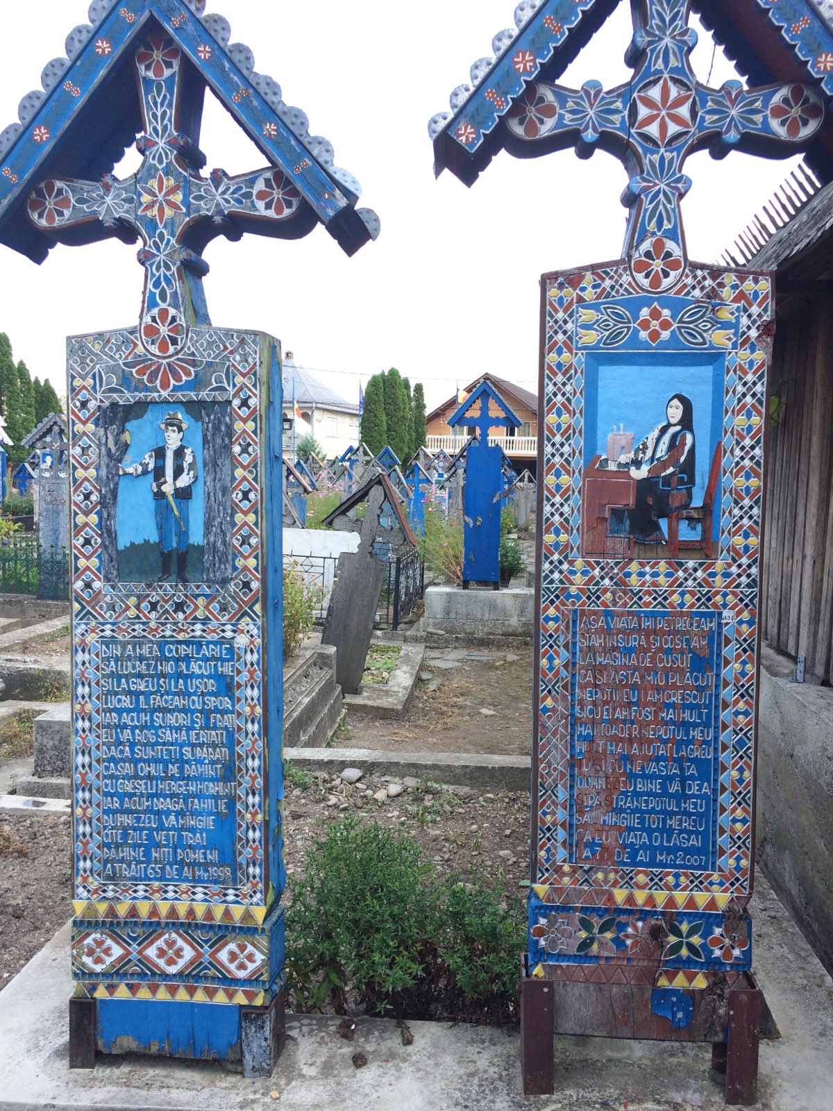 Examples of brightly painted wooden tombstones in the Merry Cemetery, Săpânța, Romania