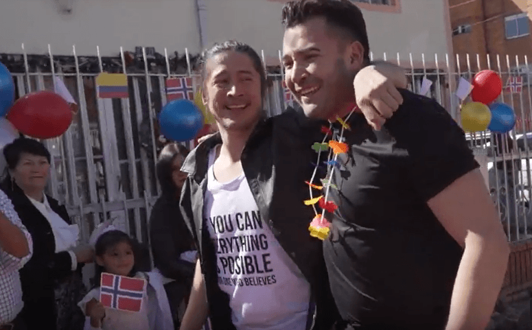 Juan (left) puts his arm around John Erik (right) during the welcome party