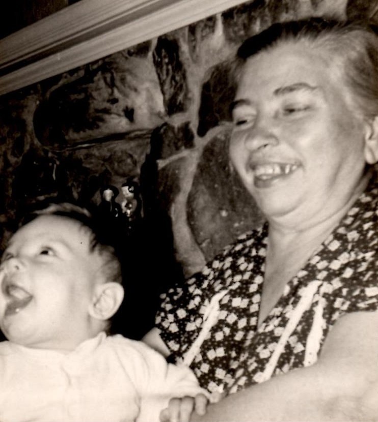 Grandmother Filomena Bucci Carlucci holding a happy baby, me, in 1950. Photo colorized and enhanced by MyHeritage