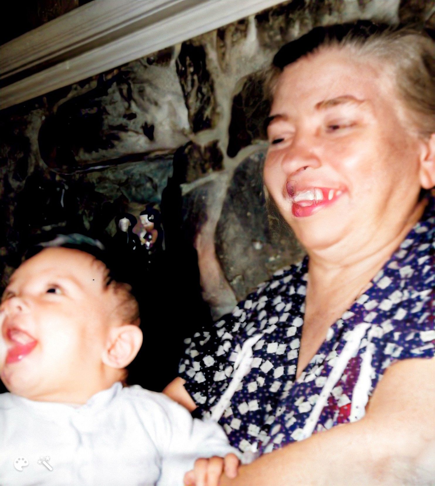 Grandmother Filomena Bucci Carlucci holding a happy baby, me, in 1950. Photo colorized and enhanced by MyHeritage