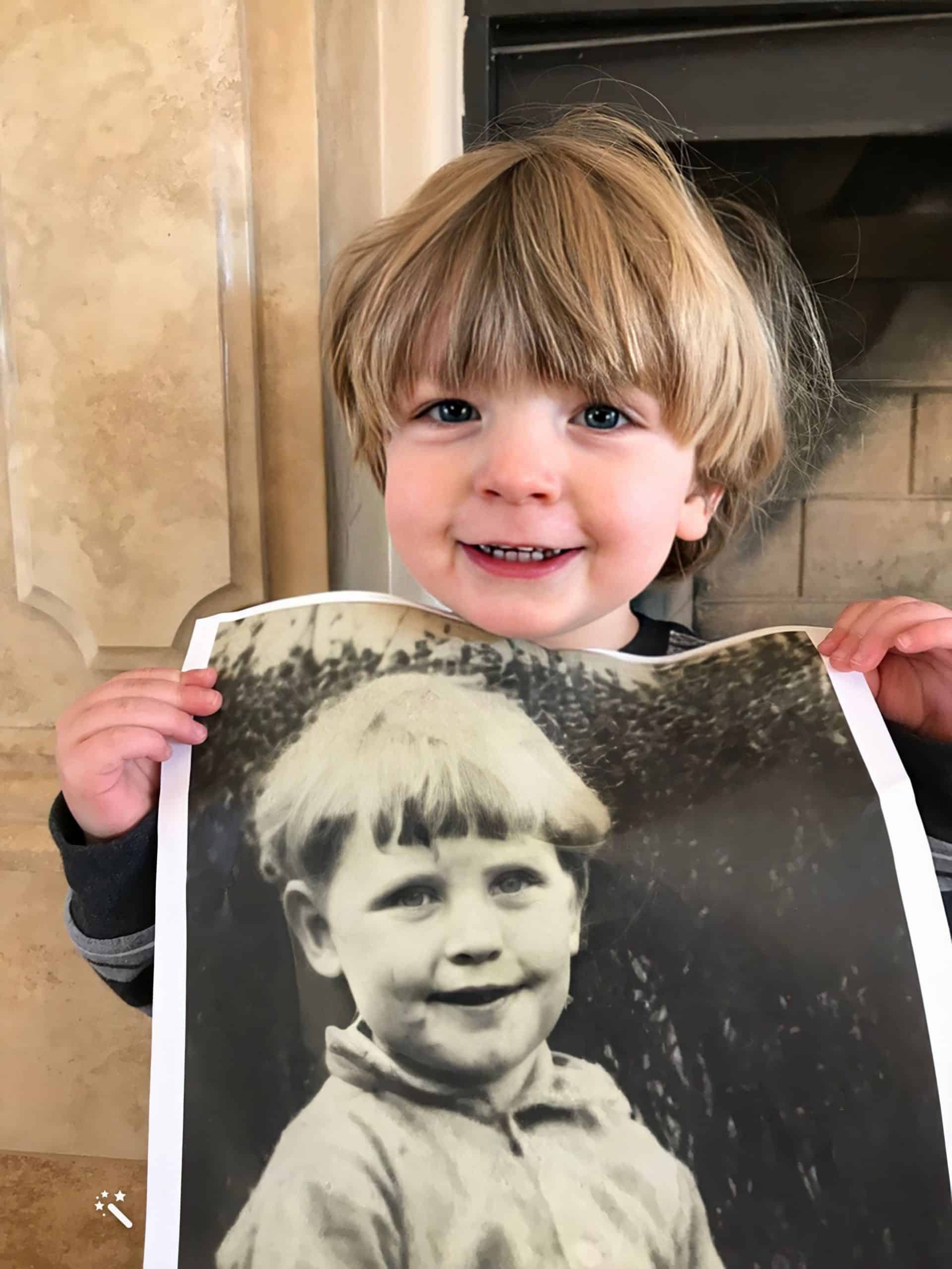 Michael Patrick Thomas holding a photo of his great-grandfather, Patrick Edward