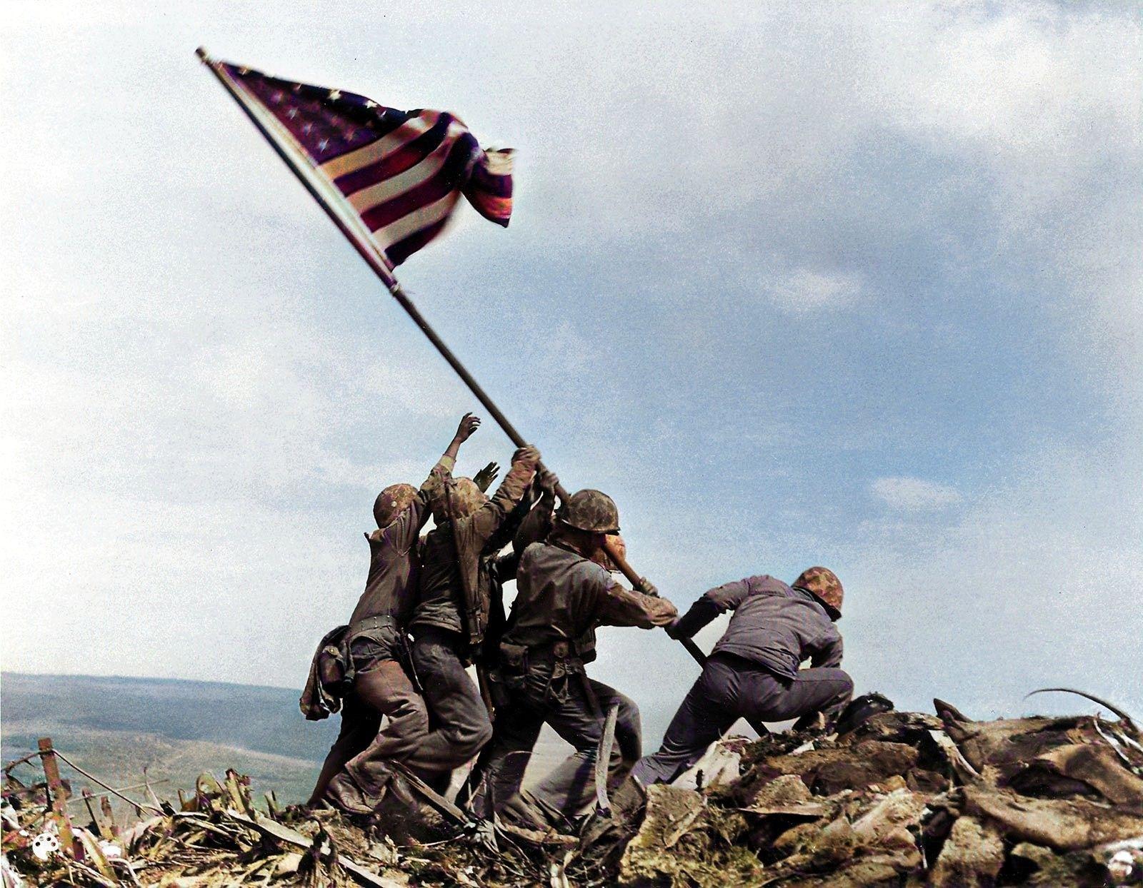 Raising the American flag. This iconic photo was reproduced as a war memorial sculpture and a postage stamp