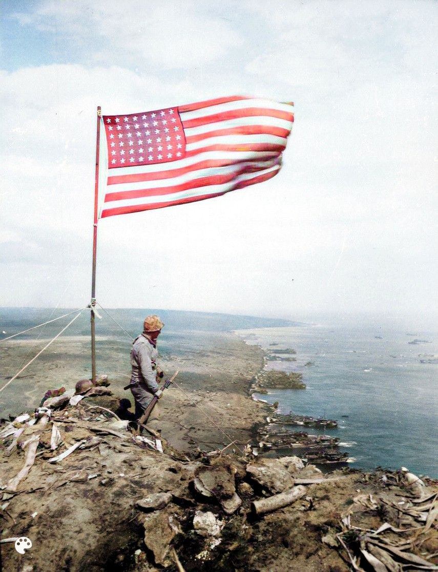 Stars and stripes fly over Mount Suribachi