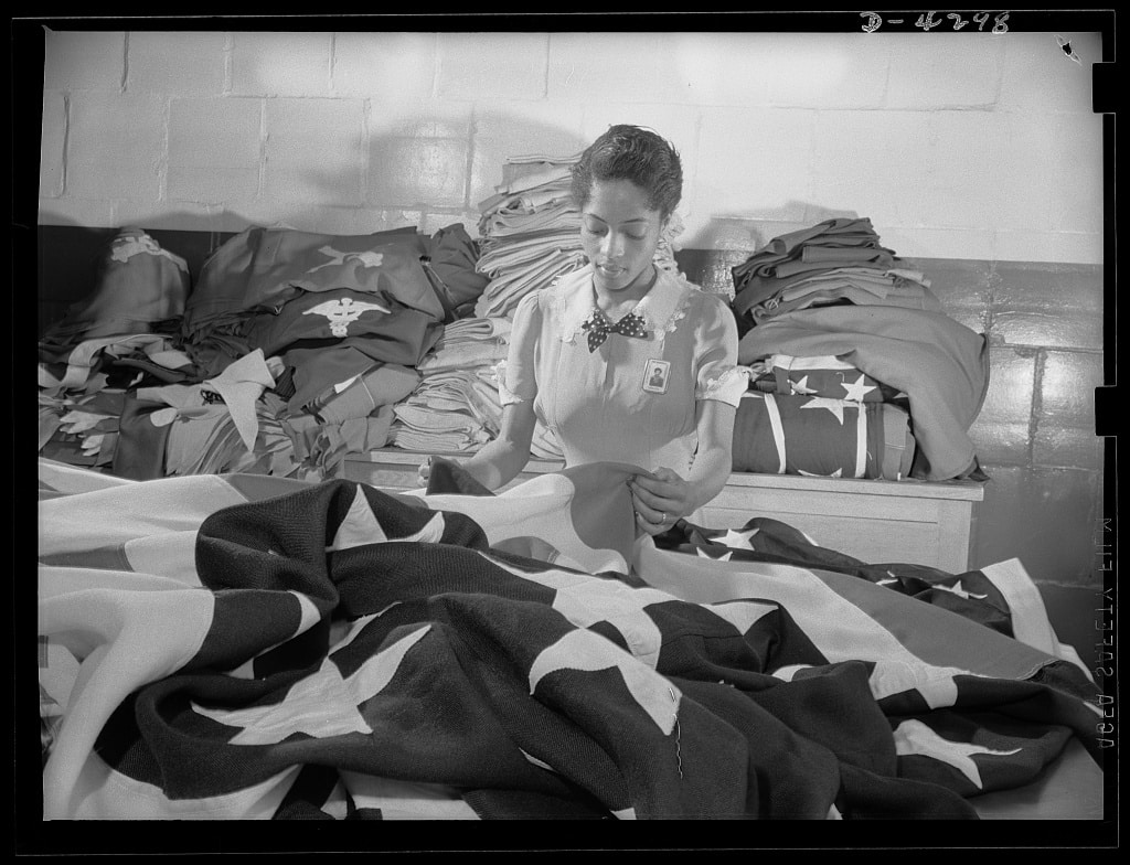 Woman worker creates American flags for military activities in the Philadelphia Quartermaster Corps depot, May 1942. Courtesy of the Library of Congress