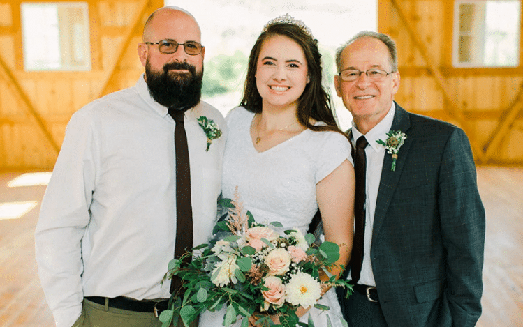 Kara with her birth father and adoptive father on her wedding day