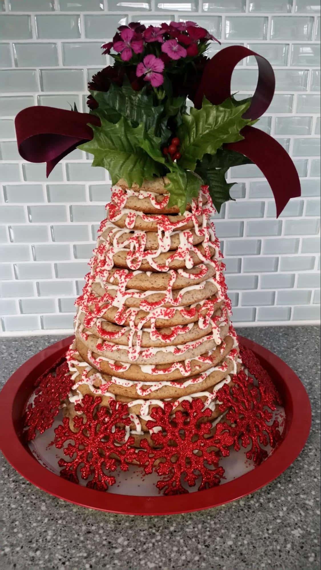 Photo of tall layered kransekeke cake decorated with flowers