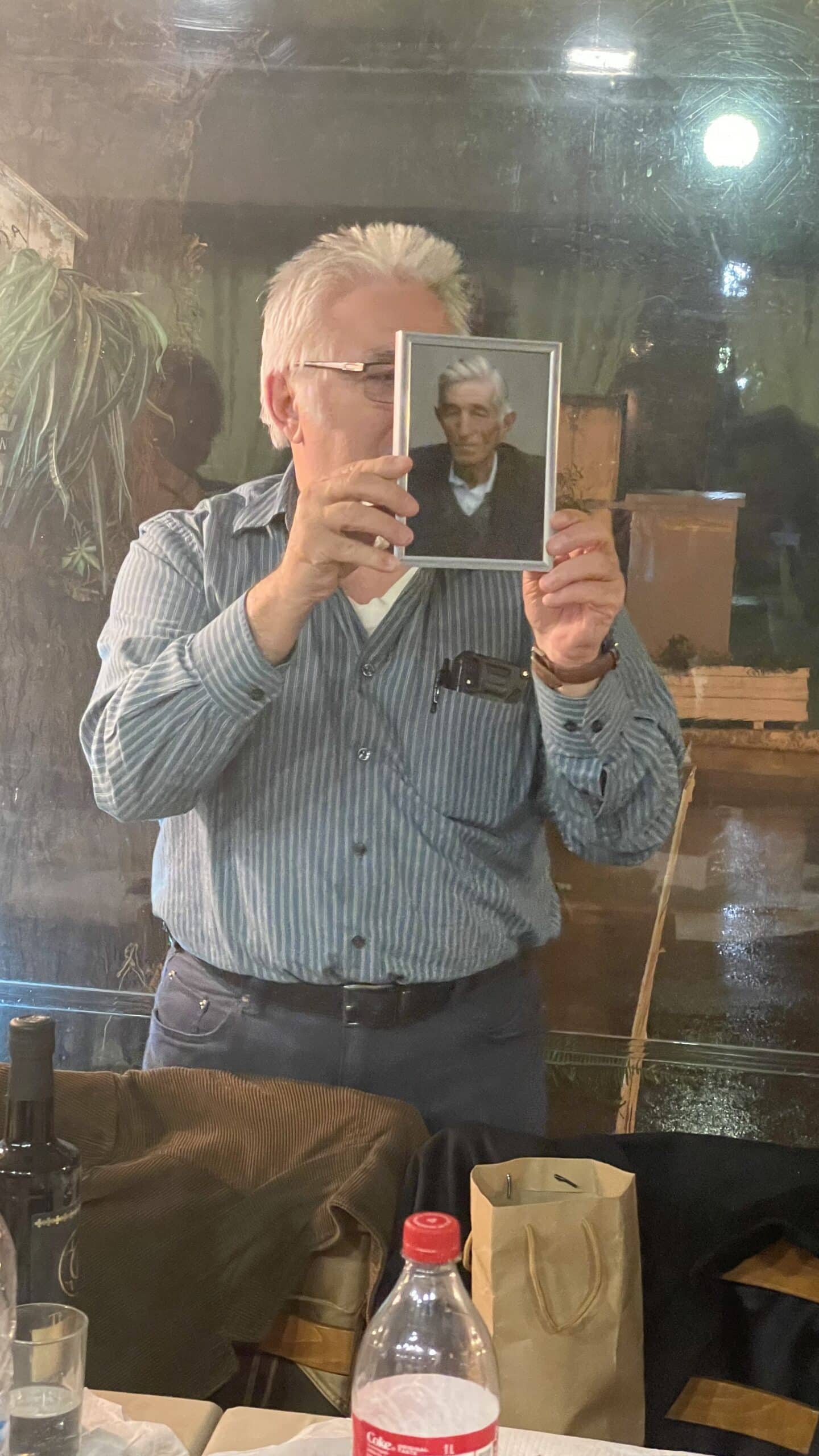 Merrill holding a photo of his birth father