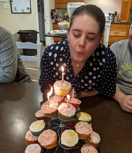 Kara celebrates a birthday with her adoptive family