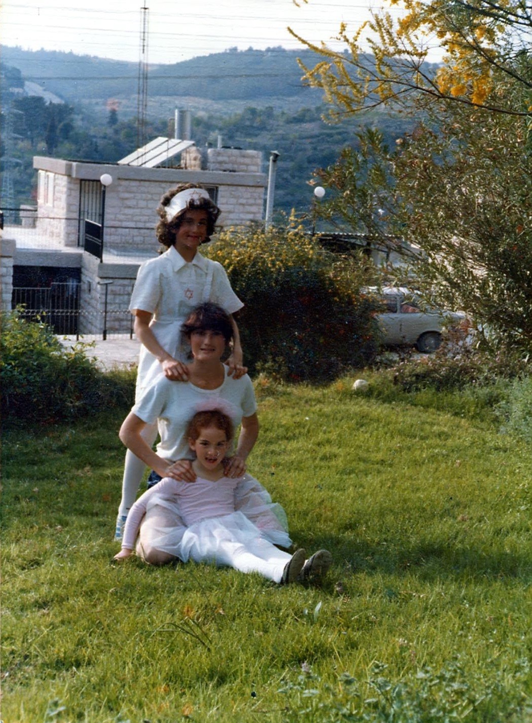 Left: MyHeritage’s founder and CEO, Gilad Japhet, wearing a wig and dressed as a nurse for the Purim holiday, together with his sisters in Jerusalem, 1978. Right: after color restoration, the photo looks as if it were taken yesterday.