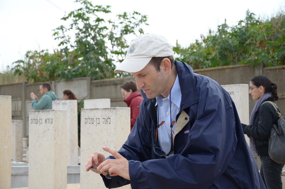 MyHeritage CEO Gilad Japhet photographing gravestones.