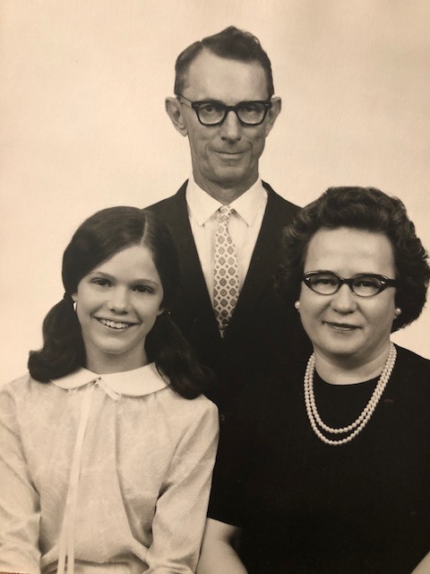 Sue at 11 years old with her adoptive parents.