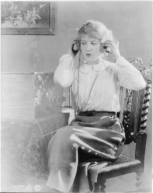 Woman listening to the radio, circa 1920. Photo colorized and enhanced by MyHeritage